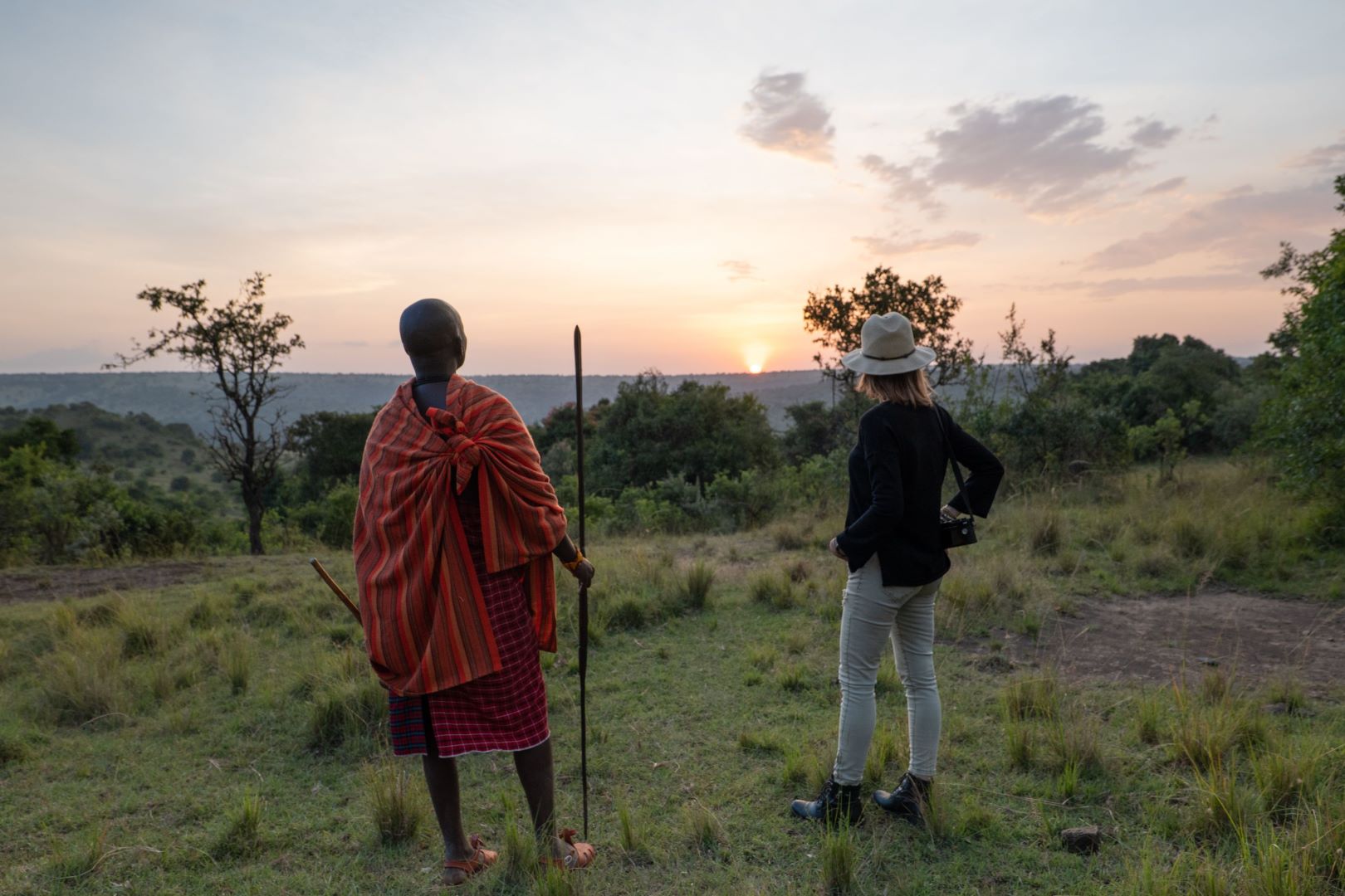 Guide and guest walking through the Maasai Mara